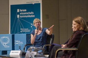 Personen beim Panel auf Bühne